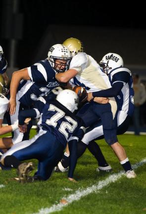 Schuylkill Haven's Tyler Naus (with the ball) is stopped by Tamaqua tacklers Garth Lakitsky (34), Carl Wittig (72) and Nicholas Hollenbach (36). BOB FORD/TIMES NEWS