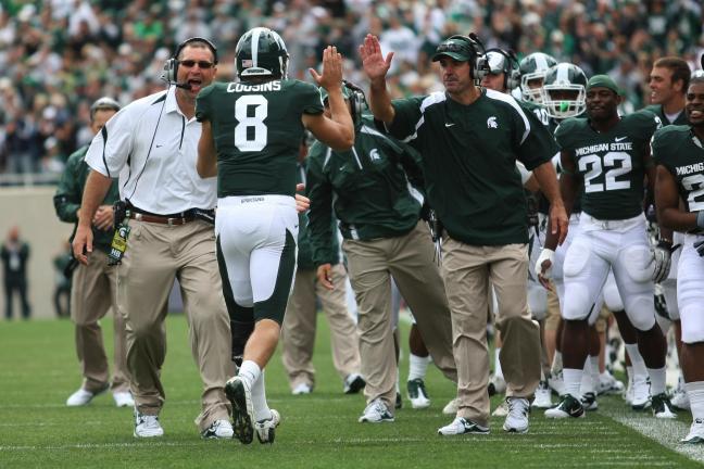 Lehighton native Dave Warner, now in his fifth year on Mark Dantonio's staff at Michigan State as the quarterback coach, gives Spartans quarterback Kirk Cousins a high five after he threw a touchdown pass in a recent game. Photo courtesy of Michigan…