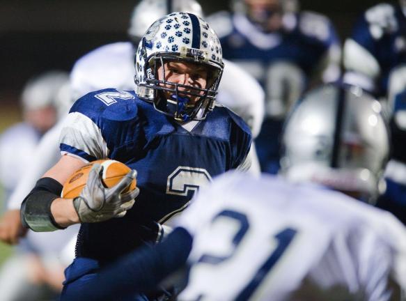 BOB FORD/TIMES NEWS Northern Lehigh's Cody Remaley breaks loose for one of his first half touchdowns as Wilkes-Barre GAR's Shaliek Powell looks on. The Bulldogs rolled to a 50-14 victory in the first round of the PIAA playoffs.