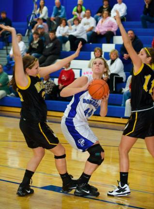 BOBO FORD/TIMES NEWS Palmerton's Kelsey Hay (44) gives a head fake before going up for a shot as Northwestern's Nycole Everett (left) and Kaleen Suter (right) defend.