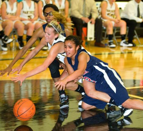 bob ford/times news Jim Thorpe's Nina Batts (right) and Celeste Robinson sandwich Panther Valley's Olivia Markovich as all three players dive for a loose ball.