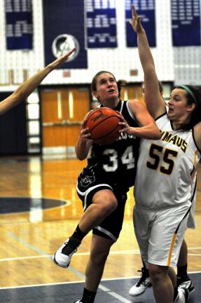 MIKE FEIFEL/TIMES NEWS Tamaqua's Allie Updike drives the lane against Anna Baer (55) of Emmaus in a semifinal matchup in the Southern Lehigh Christmas Tournament.