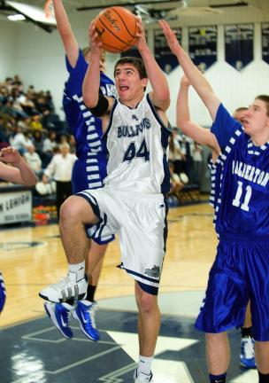 BOB FORD/TIMES NEWS Northern Lehigh's Caleb Johnson (44) goes up for two as he drives the lane in between Palmerton's Bretty Snyder and Tyler Svetik (11).