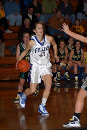 ron gower/times news Marian's Danielle Tristani (45) drives to the basket as Nativity's Jackie Ditzel trails from behind.