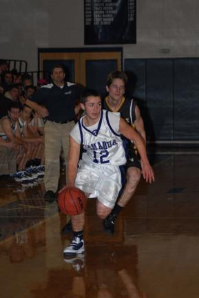 ron gower/times news Tamaqua's Spencer Bennett (12) heads up the court as Panther Valley's Nate Mattewson chases from behind.