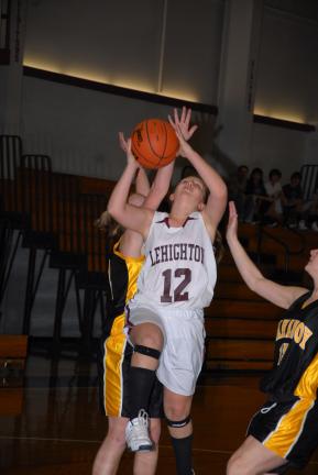 RON GOWER/TIMES NEWS Lehighton's Taylor Yurasits (12) drives to the basket through Mahanoy Area defenders.