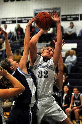 MIKE FEIFEL/TIMES NEWS Northern Lehigh's Sonya Josephson goes up for a shot as Blue Mountain's Corinne Foster tries to block it. Josephson scored her 1,000th point in the game won by the Lady Bulldogs by a score of 66-57.