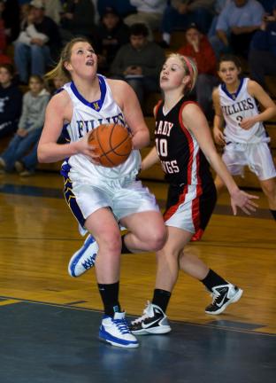 bob ford/times news Marian's Gillian Ferko (left) drives to the basket as Juli Weber defends for Tri-Valley.