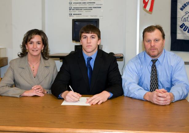 Bob Ford/TIMES NEWS Northern Lehigh's Matt Gill, center, signs a letter of intent to continue his academic and athletic careers at Lafayette College. With Gill are his parents, Karen and Jack.