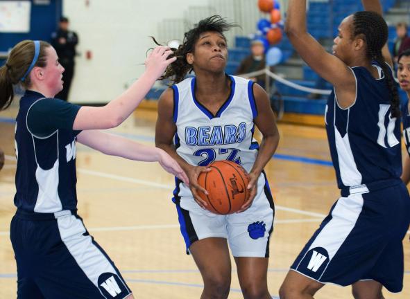 BOB FORD/TIMES NEWS Pleasant Valley's Kelly Harris gets ready to go up for a shot between the defense of Pocono Mountain West's Katie Schickling (left) and Stephanie Davis (right).