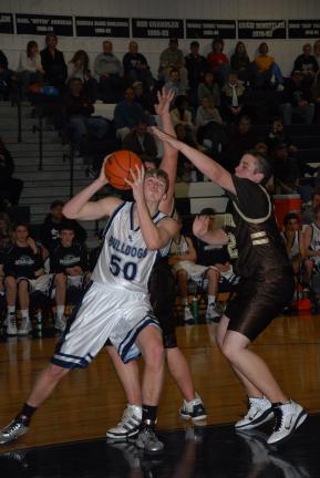 RON GOWER/TIMES NEWS Northern Lehigh's Lucas Pierce (50) looks up at the basket before taking a shot as Catasauqu's Jared Strong defends.