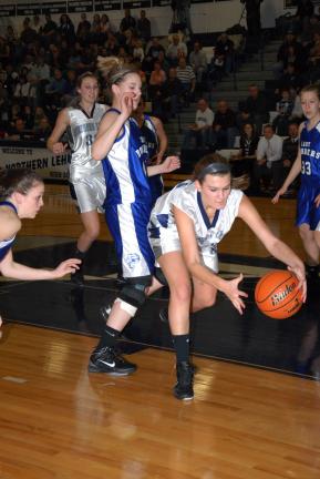 Northern Lehigh's Lauren Oertner reaches for a loose ball as Palmerton's Kelsey Hay moves in from behind.