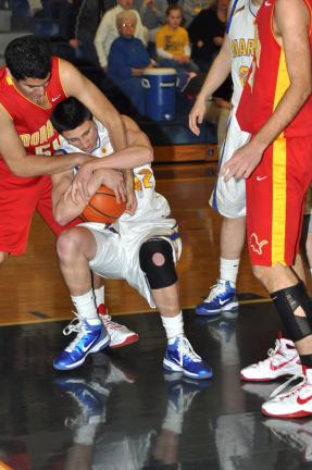 RON GOWER/TIMES NEWS Marian's Anthony Agosti tries to hang on to the ball as Moravian Academy's Sameer Singh reaches over him to try and pull it away.