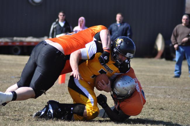 RON GOWER/TIMES NEWS Panther Valley Breaker Boys quarterback Nate Shook (7) is brought down by a pair of Schuylkill County Wolfpack defenders.