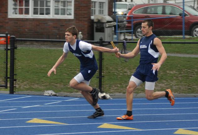 ron gower/times news Eric Herzog, front, takes baton from Tamaqua teammate Zach Lakitsky in 400 meter relay race.