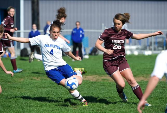 BOB FORD/TIMES NEWS Palmerton's Casey Rinfret (4) takes a shot on goal as Lehighton midfielder Kacy Beck moves in from behind. Rinfret scored two goals as the