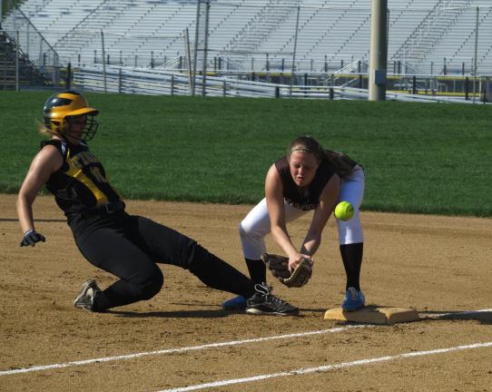 LINDA ROTHROCK/Special to THE TIMES NEWS Northwestern Lehigh's Nicole Metzger slides back in to first as Catasauqua's Amanda Strohl misses the throw.