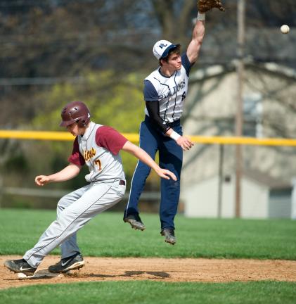 BOB FORD/TIMES NEWS Northern Lehigh's Jake Kern jumps high for a late throw as Lehighton's Alex Storm pulls in safely. The Indians wound up beating the Bulldogs 14-4 in the non-league contest.