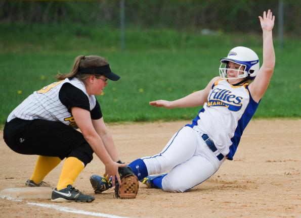 BOB FORD/TIMES NEWS Marian's Kayla Knight slides into third base safely as Panther Valley's Krista Knepper covers.