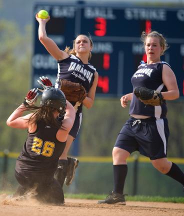 BOB FORD/TIMES NEWS Northwestern's Brooke Heller tries to break up a douoble play attempt, but Tamaqua's Chey Bates makes the throw to complete it. Brianna Boyle of the Raiders looks on.