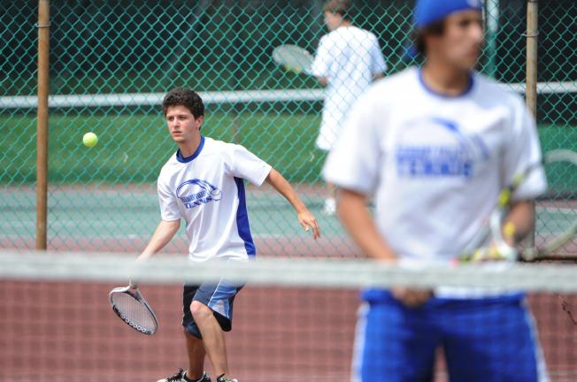 Pleasant Valley's Joe Osinski (left) returns the ball as teammate Vince Voulo waits at the net. The Bears' doubles team dropped a 3-6, 7-5, 6-3 decision in the opening round of the District 11 Class AAA doubles tournament on Friday.