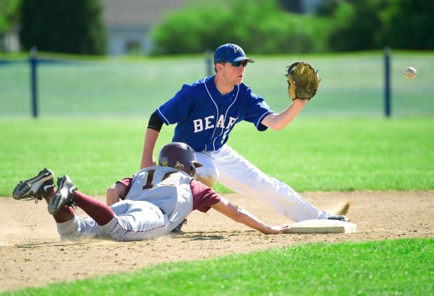 bob ford/times news Pleasant Valley shortstop Drew Borger (right) awaits the throw at second base as Lehighton courtesy runner Parker David dives back safely.