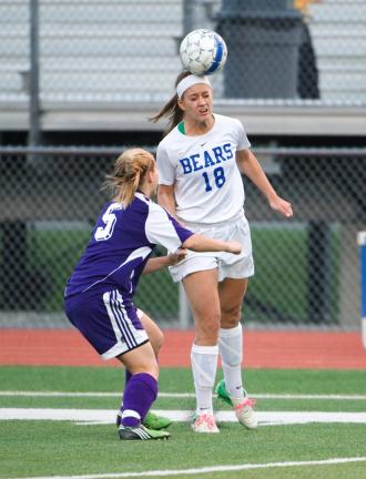 bob ford/times news Pleasant Valley's Kayla Dorney (18) heads the ball away from East Stroudsburg South defender Cortney Gill.