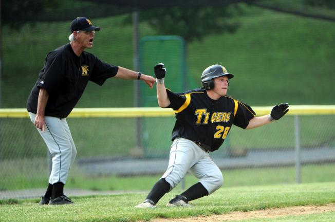 Nancy Scholz/special to the times news Northwestern coach Len Smith (left) watches the action on the field and directs baserunner Tyrone Williams back to third base.