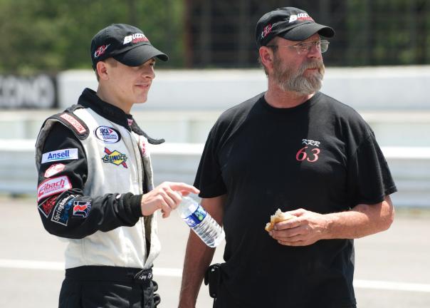 bob ford/times news Driver Kory Rabenold (left) and his crew chief and father Buzzy Rabenold check out action on the track during ARCA qualifying on Friday.