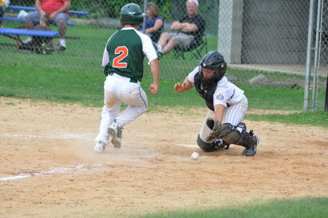 RON GOWER/TIMES NEWS Franklin Township's Zach Knox runs home as the throw to the plate drops in front of Towamensing catcher Mike Sander during Senior Babe Ruth league game in Forest Inn, Sunday.