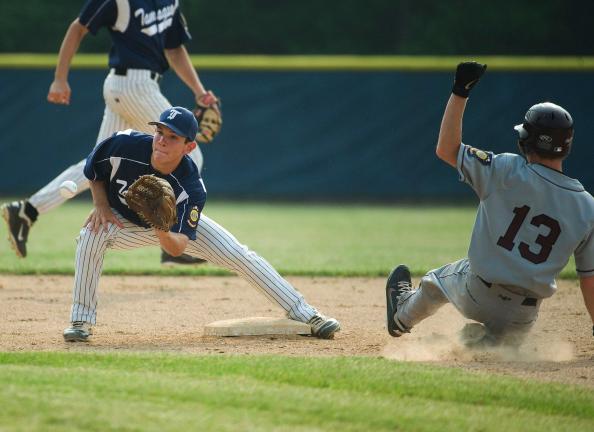 BOB FORD/TIMES NEWS Tamaqua's Matt Delborrello takes the throw to try and put the tag on Schuylkill Valley's Derek Tarconish during last night's Legion game in Tamaqua.