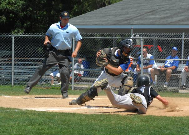 RON GOWER/TIMES NEWS Joe Weismith, catcher for the Birches, manages to turn around and put the tag on Bath's Evan Allman at home during NORCO Legion baseball action, Sunday.