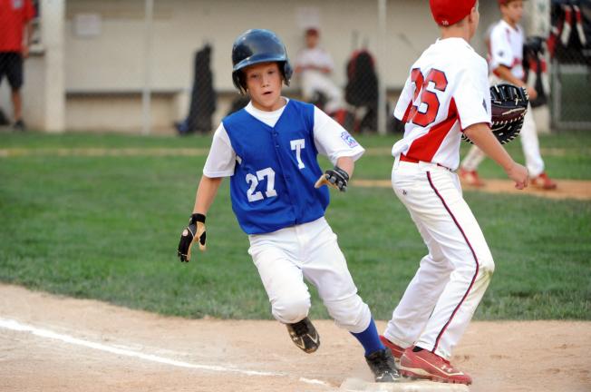 NANCY SCHOLZ/Special to THE TIMES NEWS Tamaqua's Nate Boyle scampers to first base safely in Wednesday's Section 6 9-10 Little League tournament game against Warwick.