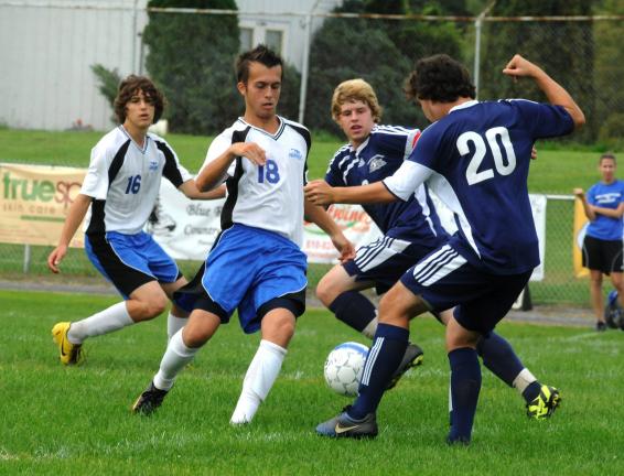 @$: Pursuing soccer ball in contest between Palmerton and Northern Lehigh on Saturday are, l-r, Lee Shehadeh (16), Trevor Sherman (18), both of the Bombers, and Channing Shiffert and Jimmy Bilger (20), both of the Bulldogs. RON GOWER/TIMES NEWS