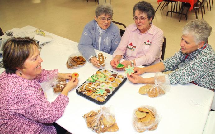 ANDREW LEIBENGUTH/TIMES NEWS Sitting with their homemade cookies during a recent fundraiser at Christ Church in McKeensburg are volunteers, from left, Susan Mantz, Dorothy Faust, President Helen Koch and Nancy Shellhamer.