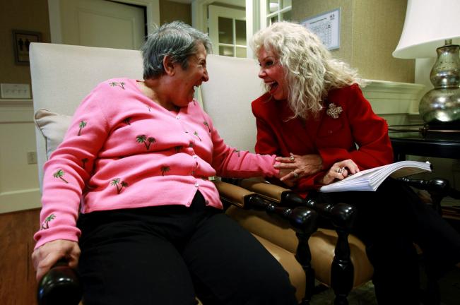 AP Photo/Charles Dharapak Alexis McKenzie, right, executive director of The Methodist Home of the District of Columbia Forest Side, an Alzheimer's assisted-living facility, shares a light moment with resident Catherine Peake recently. Dementia can…