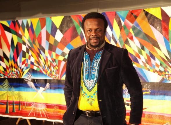 AL ZAGOFSKY/SPECIAL TO THE TIMES NEWS Award-wining African artist and Arts Ambassador for Nigeria to the United Nations Ibiyinka Alao with his painting The Eagle. Alao 's exhibition, Eternity in Our Hearts opens Feb. 21 at the Mauch Chunk Museum.