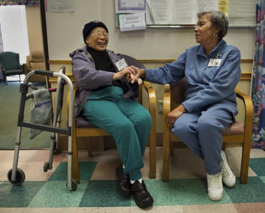 SHNS PHOTO BY RANDY PENCH/THE SACRAMENTO BEE Loretha Loggins, 83, right, visits with client Anna Chow, 87.