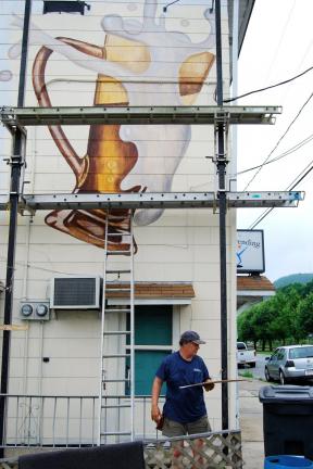 SPECIAL TO THE TIMES NEWS Michael Pyrdsa works on his 20-foot high mural.