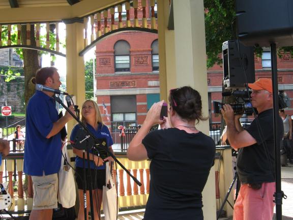 STACEY SOLT/SPECIAL TO THE TIMES NEWS ABOVE: Best of the Road 2012 Rally members Dusty and Nikki Green, left, speak to members of the Jim Thorpe community during their welcome to the town while being filmed by a video crew from the Travel Channel…