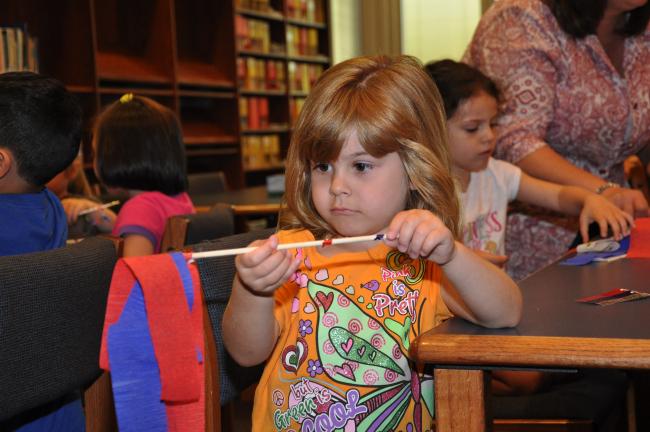 AMY MILLER/TIMES NEWS Ellie Wilds inspects the streamer that she made during a recent day camp at Penn-Kidder Elementary School in Jim Thorpe.