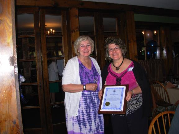 ADELE ARGOT/SPECIAL TO THE TIMES NEWS Monroe County Commissioner Suzanne McCool, left, presented retiring Dawn Olson, Monroe County Extension Director, right, with a citation from the County Commissioners' office. The citation recalls Olson's over…