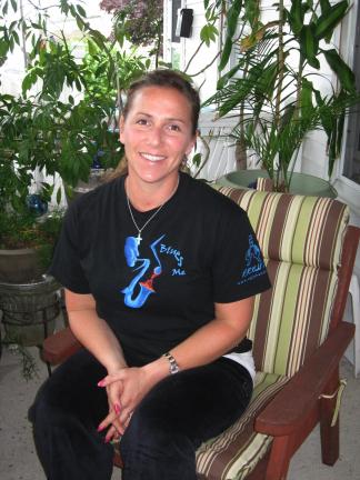 STACEY SOLT/SPECIAL TO THE TIMES NEWS Lauren Daderko Buscher sits outside of her mother's Lansford home. She is now a successful businesswoman living in California, but just a few years ago was struggling to overcome an addiction to heroin.