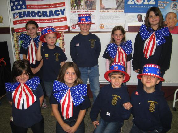 STACEY SOLT/SPECIAL TO THE TIMES NEWS ABOVE: First-grade students at SS. Peter and Paul School, Lehighton, wear patriotic attire during the quadrennial presidential election assembly. During the assembly, students learned about the election process…