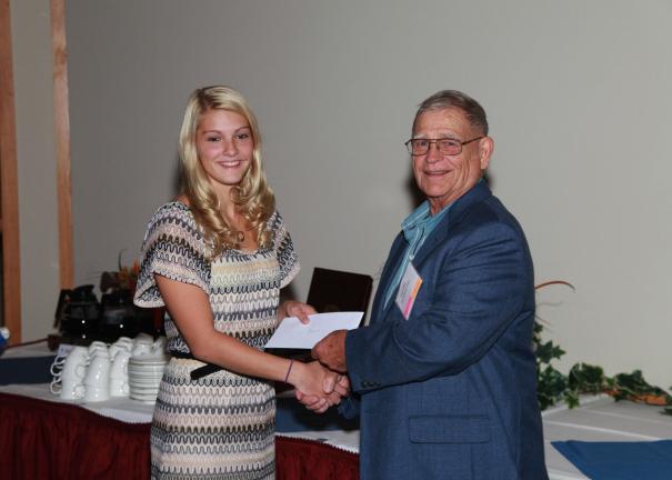 Peter Blynn presents a check from the Palmerton Area High School Class of 1952 in honor of its class president, the late Peter A. Turko, to the Palmerton Area High School Environmental Club. Accepting on the club's behalf is Katie Pielmyer, a member…