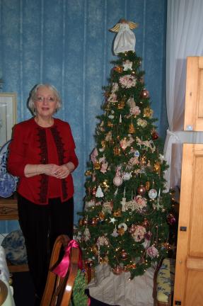ABOVE: Ruthann Kistler, with her Victorian Christmas tree, says the French country dining room is her favorite room. The Kistlers' breakfast room has two smaller trees. One is decorated with her mother's old cookie cutters. The other's ornaments are…