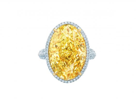This image released by Tiffany's shows a 15.04ct Oval Fancy Vivid Yellow Diamond Ring with white diamonds and set in platinum and 18k yellow gold. (AP Photo/Tiffany's)