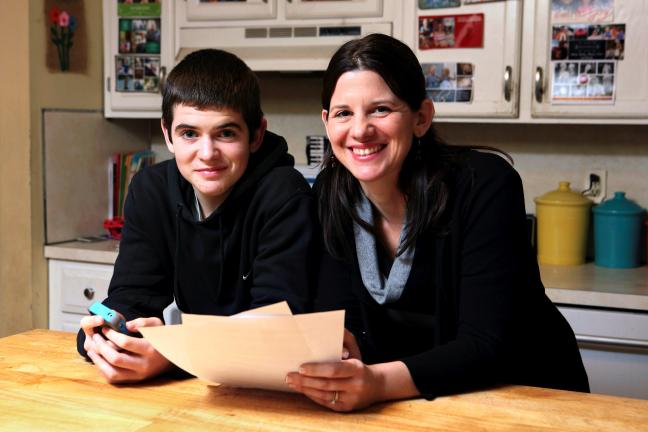 AP Photo/Michael Dwyer Janell Burley Hofmann, right, holds a copy of the contract she drafted and that her son Gregory, left, signed as a condition for receiving his first Apple iPhone.