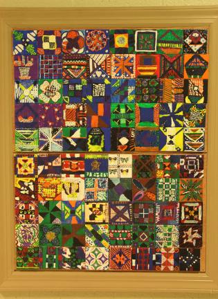 ANDREW LEIBENGUTH/TIMES NEWS Pictured is a section of artwork permanently on display in the Tamaqua Middle School. Students from the class of 2017 used ceramic tiles to create their own interpretation of Amish quilt styles.