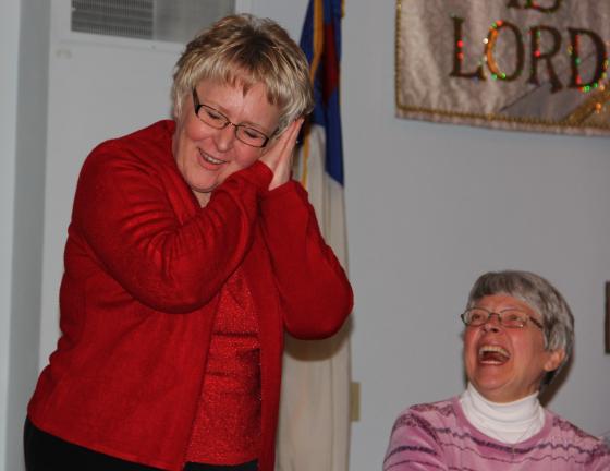 ANDREW LEIBENGUTH/TIMES NEWS Kay Zern laughs as Judy Lisella pretends to sleep during a marriage enrichment skit. Both are from Mahoning Valley.